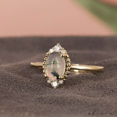 a close up of a ring with a stone in the middle