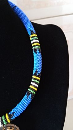 African Pendant Necklace, African Pendant Jewelry, African Beaded Necklace, Zulu Beaded Necklace, Bush Blue Necklace, Gift For Her This stunning pendant necklace is superbly crafted which makes you stands out in any occasion. Main Color - Bush Blue. Different colors of your choice can be available. Wholesale available at a fair price. For any query please send me a convo or an e-mail. Happy Shopping Blue And Black Beads Bohemian Necklace, Bohemian Blue And Black Beaded Necklaces, Blue Beaded Chain Beads As Gift, Blue Beaded Chain Beads For Gift, Traditional Blue Necklaces With Tiny Beads, Bohemian Blue Necklace With Black Beads, Traditional Blue Necklace With Tiny Beads, Blue Necklace With Black Beads For Gift, Adjustable Blue Beaded Necklace With Large Beads