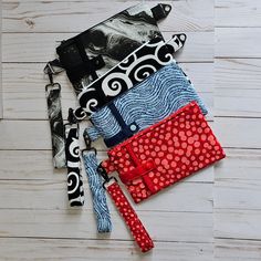 several different types of purses on top of a wooden floor