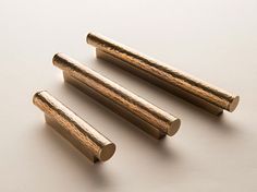 three pieces of brass are shown on a white surface