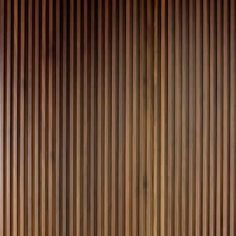 a wooden wall with vertical slats in the middle and bottom part showing light brown