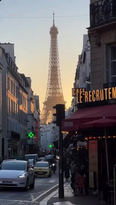 the eiffel tower is in the distance on this street