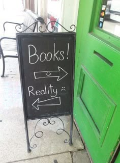 a green door with a sign that says books reality and an arrow pointing to the right