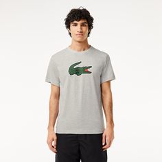 A T-shirt designed for intense exercise by Lacoste, sporting experts since 1933. Made from technical jersey, with cotton for comfort and Ultra Dry technology to wick away moisture. Plus an iconic, XL crocodile print for Lacoste signature style. Crew Neck T-shirt For Light Sports, Crew Neck Jersey T-shirt For Sports, Gray Crew Neck T-shirt For Light Sports, Athletic Heather T-shirt With Logo For Sports Season, Logo Print Crew Neck T-shirt In Athleisure Style, Logo Print Crew Neck T-shirt For Athleisure, Sportswear Jersey Crew Neck Top, Sporty Athletic Heather T-shirt With Moisture-wicking, Sportswear Jersey Tops With Crew Neck