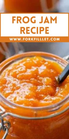 a jar filled with orange jam on top of a table