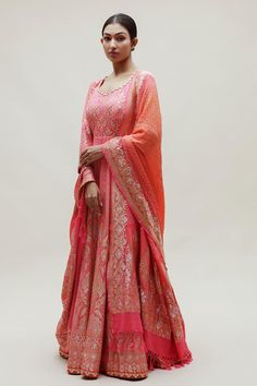 Peach floor length attached can-can anarkali with all over bandhani and floral pattern and gota patti neckline. Comes along with intricate shikari bandhani banarasi dupatta in pure georgette.
Components: 2
Pattern: Woven, Embroidery
Type Of Work: Bandhani, Floral
Neckline: Round Neck
Sleeve Type: Three Quarter Sleeves
Fabric: Georgette
Color: Peach
Other Details: 
Anarkali:
Length: Approx: 56-58 inches
Attached can-can
Back cut-out detailing with heart tassels
Dupatta:
Floral pattern with tassel Anarkali Salwar Kameez With Pallu, Transitional Anarkali Set In Jamawar, Pink Anarkali Set For Transitional Season, Unstitched Anarkali Set In Traditional Drape, Semi-stitched Anarkali Set With Dupatta For Transitional Season, Anarkali Choli With Chikankari Embroidery, Traditional Maxi Length Sharara With Zari Work, Floor-length Cutdana Salwar Kameez For Reception, Anarkali Set With Cutdana On Jamawar Fabric