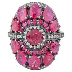 The 6.72 Carat Diamond and Ruby Cluster Ring epitomizes luxury and refined craftsmanship, combining the timeless allure of diamonds with the vibrant beauty of rubies. This ring features a stunning cluster design, where carefully selected gemstones are arranged in a captivating display of brilliance and color. At the center of the ring, a collection of dazzling diamonds forms a radiant focal point. These diamonds, totaling 6.72 carats, are chosen for their exceptional clarity and brilliance. Each diamond is meticulously set to maximize its sparkle, creating a mesmerizing effect that captures light from every angle. The cluster setting ensures that the diamonds are securely held, allowing for a seamless and dazzling presentation. Surrounding the central diamonds, vivid rubies add a rich, con Cluster Design, Contemporary Ring, All Gems, Deep Red Color, Ruby Stone, Modern Ring, Diamond Cluster Ring, Diamond Cluster, Belleza Natural