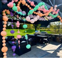 an outdoor party with balloons and grills