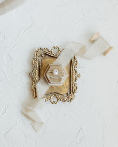 a piece of glass with a diamond in it sitting on top of a white wall