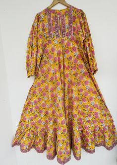 "Cotton maxi, long dress, floral dress, boho dresses, hippie dresses, dress with border, bohemian maxi, vintage gown, yellow maxi, umbrella maxi, marigold dress for special occasion, gift for her, dresses with border, INDIAN dresses, cotton dresses, floral dress, border dresses, printed dress, long maxi, indian wholesale dresses, indian seller, indian cotton maxi     Feel beautiful and confident throughout your days wearing our block printed outfits, made with high quality soft and breathable cotton fabric.  The print on the dress is known as \"BLOCK PRINT\" which is centuries old technique of Indian textile carried out  by local artisans of Jaipur (INDIA) MEASUREMENTS (in inches): Size XXS-: Bust- 34″ | Shoulder- 13.5″ | Length- 51″ Size XS-: Bust- 36″ | Shoulder- 14″ | Length- 51″ Size S Bohemian Cotton Maxi Dress With Printed Motifs, Multicolor Printed Maxi Dress, Bohemian Maxi Dress With Printed Motifs, Bohemian Multicolor Printed Maxi Dress, Bohemian Cotton Maxi Dress, Bohemian Long Dress With Printed Motifs, Bohemian Long Dresses With Printed Motifs, Beach Maxi Dress With Printed Motifs, Spring Ceremonial Maxi Dress