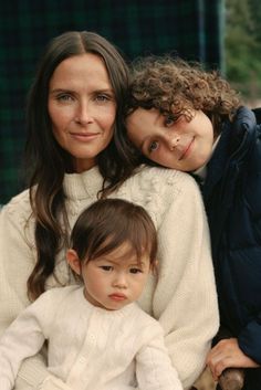 two women and a child posing for the camera