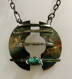 Contemporary design, attractive large necklace with turquoise. Patinated in black, green, yellow tones. Fascinating and unique. Turquoise Chrysocolla Necklace With Large Pendant, Unique Blue Necklace With Patina, Green Oxidized Pendant Necklace, Unique Oxidized Round Pendant Necklace, Unique Turquoise Necklace With Patina, Green Handmade Modern Jewelry, Modern Green Handmade Jewelry, Green Bohemian Hand Forged Necklace, Turquoise Chrysocolla Necklace With Patina