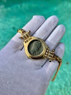 "Antique original Roman Coin Pendant with diamond side stones and set in a Cuban style 18k gold chain. Roman Coins date back to the 4th Century BCE around the year 326. This Bronze Roman Coin is estimated to originate in 325AD, with a detailed depiction of Constantius Gallus, the tyrannical nephew of Constantine I. A stunning vintage piece of heirloom quality. The protruding bezel setting also provides an additional layer of support to the antique coin. ✔ Metal: Yellow Gold ✔ Metal Purity: 18K ✔ Fine Jewelry With Single Cut Diamonds And Oval Link, Luxury Collectible Cubic Zirconia Jewelry, Exquisite Gold Jewelry Collectible, Gold Medallion With Single Cut Diamonds, Collectible Coin-shaped Elegant Necklace, Luxury Tarnish Resistant Coin Jewelry, Heirloom Medallion Diamond Jewelry, Luxury 14k Stamped Cubic Zirconia Jewelry, Antique Gold Necklaces With Single Cut Diamonds