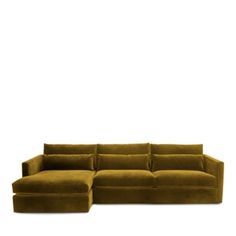 a large brown couch sitting on top of a white floor