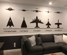 a living room filled with furniture and wall decals