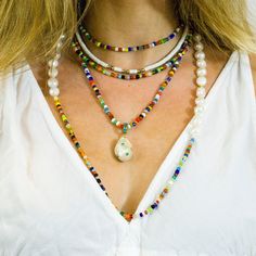 "Bright, vibrant beads make this necklace perfect addition to your summer sundress or a white blouse. African glass beads and white freshwater pearls are hand knotted along the silk cord to create a colorful and bright strand. Alone or layered with your favorites, this necklace exudes a playful, eclectic bohemian elegance. Necklace: 43\" Layer this necklace with: https://www.etsy.com/listing/637252353/baroque-pearl-and-turquoise-necklace?ref=shop_home_active_2 You might also like: https://www.et White Shell Necklace With Pearl Charm For Vacation, Summer Multi-strand Colorful Beaded Necklaces, White Pearl Jewelry For Beach, White Pearl Jewelry For The Beach, White Pearl Beach Jewelry, White Necklace For Festivals, Elegant White Shell Necklace For Summer, Pearl Strand Beaded Necklaces For Beach, Festival Pearl Jewelry With Colorful Beads