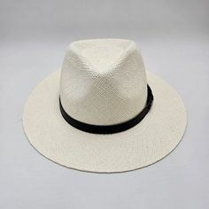 Panama Hat Indiana Style with leather strap, meticulously crafted to evoke timeless sophistication. Each strand woven with precision, it exudes vintage charm and unparalleled elegance, offering a stylish nod to a bygone era. This Panama hat was hand woven by skilled natives in Ecuador and it was carefully completed in Italy. Made from the fibers of the Toquilla Palm plant native to Ecuador. The hat gained international fame during the construction of the Panama Canal in the late 19th and early 2 Palm Plant, Panama Canal, Sports Caps, Weaving Process, Bygone Era, Flat Cap, Ivory White, Hat Making, Hat Sizes