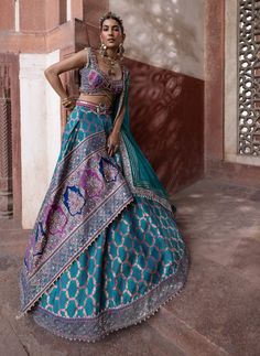 This enchanting bandhani banarasi lehenga features a stunning jamawar panel, creating a beautiful fusion of traditional craftsmanship and modern elegance. The embroidered blouse showcases a scalloped neckline and delicate cutwork detail on the hem, enhancing its charm. Paired with a sheer dupatta adorned with floral butis and gota, the ensemble is elevated by a waist belt embellished with mirrors, adding a touch of sparkle and refinement to the overall look. Silk Lehenga, Organza Dupatta, Waist Belt, Cut Work, Embroidered Blouse, Silk Blouse, Lehenga, Overalls, Silk