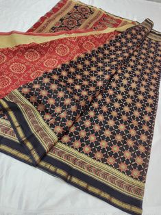 This beautiful Ajrakh hand block printed Chanderi saree has a sleek golden zari border running all along the saree and pallu. These Sarees are handmade and hand block printed with natural dye and vegetable color. The fabric of these Chanderi Sarees is silk cotton blend which makes it very soft, airy, and perfect for all seasons. There's something about Ajrakh Sarees that makes a lady look fierce and graceful, all at one time. The print might have slight irregularities in the pattern & colour Traditional Block Print Cotton Silk Pre-draped Saree, Black Chanderi Traditional Wear With Block Print, Unstitched Tussar Silk Saree With Bandhani Print, Black Block Print Saree With Traditional Drape, Unstitched Black Saree With Block Print, Black Saree With Block Print And Traditional Drape, Black Traditional Wear With Block Print, Unstitched Bandhani Print Slub Silk Saree, Unstitched Chanderi Bandhani Print Saree