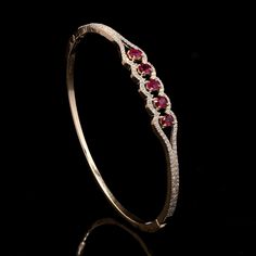 18k Gold Bracelet with round cut diamond and Oval shape Rubystudded Bracelet Diamond description: Gross weight:12.092 gms approx Net weight:11.752 gms approx(includes gold weight only) Diamond weight:0.70 carat  round cut diamond color purity: HI VS SI Ruby weight: 1.00ct (heated) We use natural diamonds only for all jewellery. Bracelet can be coustomised in 18K Yellow Gold, gold color can be , white gold, rose gold  size of bracelet can be customised, diamond size can be changed all may vary wi Ruby Diamond Bangles Unique, Oval Bracelet Diamond, Ruby Diamond Bracelet, Fine Jewelry Ruby Diamond Bracelet With Accents, Fine Jewelry Ruby Bracelet With Diamond Accents, Elegant Ruby Bangle With 17 Jewels, Ruby Bracelet Gold, Fine Jewelry Ruby Diamond Bangle Bracelet, Elegant Yellow Gold Ruby Bangle