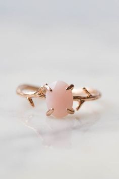 Our dainty Pink Opal Ring is part of our new Birthstone Ring Collection! This beautiful, yet delicate ring is made with genuine, untreated Pink Opal. The October Birthstone represents hope + compassion. Not to mention, the unique look of the whimsical vine ring setting will ensure endless compliments. If you're looking for a ring with style, quality and true meaning, look no further.#pinkopalring #rosegoldring #daintyrings #octoberbirthstone #rings #jewelry #wanderandlustejewelry #opalring Pink Stone Ring, Pink Opal Ring, Pink Stone Rings, Vine Ring, Dainty Rings, Clothes Jewelry, October Birthday, Ring Opal, Ring Birthstone