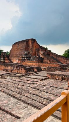 the ruins of an ancient city under a cloudy sky