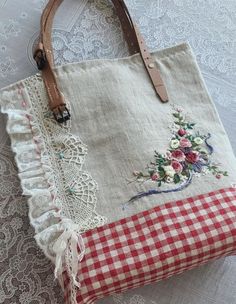 a handbag sitting on top of a table next to a lace doily covered pillow