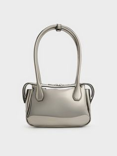 With a high-shine mirror-metallic finish, this Bosie top handle bag in pewter will set you apart wherever you go. Featuring two elongated handles and a distinctive shape, this cute and chic piece is an updated iteration of the classc lady-like bag style. Equipped with a zip closure that will keep your belongings secure, it exudes a modern femininity that can be dressed up or down to suit the occasion -- it will work well for both work days and the weekends. Charles Keith, Bag Style, Handle Bag, Top Handle, Fashion Bags, Top Handle Bag, Handles, Mirror, Handbags