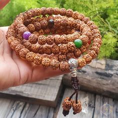 "This Chakra Mala is made with 108 x 9mm Rudraksha beads that are naturally stained and oiled to achieve their  aged appearance and 7 stones representing the 7 chakras. There are 108 Rudraksha beads - 27 between the Om Mani Padme Hum in Tibetan script Inscribed Guru Bead and the first and seventh Chakra stones and 9 between each of the Chakra stones  📿Mala Beads, or Buddhist prayer beads, are a set of sacred rosary beads for chanting & counting mantras, meditation, prayer, yoga & reflection. Mala is a Sanskrit word meaning garland. The Tibetan word for mala is threngwa (Tibetan  ཕྲེང་བ) . Seed malas are some of the most common malas used in Tibet and Nepal. Buddhist Prayer Beads are sometimes referred to as Japa mala, japa is a Sanskrit word meaning \"repeat internally\".📿 Specifications Spiritual Gemstone Beads Mala For Puja, Spiritual Round Beads Mala For Puja, Spiritual Mala With Round Beads For Puja, Spiritual Mala For Puja With Round Beads, Multicolor Spiritual Bracelets For Puja, Spiritual Multicolor Bracelets For Puja, 8mm Beaded Mala For Festivals And Gifts, Healing Mala With Round Beads For Festivals, Round Beaded Bracelets For Meditation And Festivals