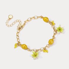 Experience the refreshing and invigorating essence of the Lemon Bracelet. Embrace nature with its sweet, juicy lemon design that evokes memories of sunny days, tropical vacations, and cool breezes. Let its vibrant flowers and fruit design add a touch of summer zeal to your style. Embrace the zesty spirit of summer and Celebrate the luxurious pleasures of nature's bounty with this delightful Lemon Bracelet! DETAILS Plating: 18K Gold Materials: 18K Gold on Brass, Enamel, Cubic Zirconia Measurement Yellow Dainty Jewelry For Summer, Dainty Yellow Jewelry For Summer, Dainty Yellow Summer Jewelry, Dainty Beach Jewelry For Spring, Dainty Spring Beach Jewelry, Delicate Gold Bracelets For Summer, Gold Flower Jewelry For Beach, Summer Flower Charm Bracelet Jewelry, Elegant Yellow Flower Bracelets