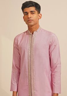 Featuring a stylish Lilac Silk Kurta Set, this ensemble includes a button-down kurta designed with a Chinese collar and a hidden placket. The hand-embroidered details on Kurta add a touch of grace and sophistication. Teamed with elegant white pants, this kurta set combines traditional elegance with contemporary style. Perfect for special occasions like Mehendi or Sangeet. Composition : Chanderi Silk Care: Dry Clean Only and Vacuum Storage This product can be customized for sleeves, length and colour Delivery : 4-6 weeks as the product is hand crafted. Check Size Guide or choose MySize for free customisation (All Sizes above XL can be made at 15% additional cost) For more information and sizes please contact fabiliciousfashion@gmail.com or visit our Copenhagen studio. About the Designer : S Cotton Silk Bandhgala With Resham Embroidery, Cotton Silk Bandhgala With Resham Embroidery For Spring, Cotton Silk Bandhgala For Designer Wear, Elegant Chanderi Bandhgala For Transitional Season, Spring Cotton Silk Bandhgala With Resham Embroidery, Spring Cotton Silk Sherwani With Resham Embroidery, Spring Embroidered Cotton Silk Sherwani, Designer Chanderi Kurta For Festive Occasions, Designer Chanderi Kurta For Eid