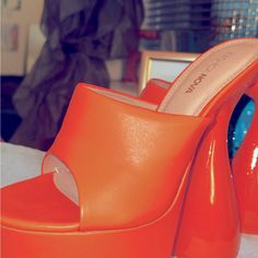 Orange Platform Slide On Heel Brand New Size 7.5 Excellent Condition Orange Platform Heels With Round Toe, Orange High Heel Platform Shoes, Orange Platform Heels With High Heel, Orange Platform Heels With Closed Toe, Orange Platform High Heels, Polyurethane Heels With Stacked Heel And Round Toe, Orange High Heel Leather Mules, Orange Heels With Padded Heel And Round Toe, Orange Round Toe Heels With Wrapped Heel