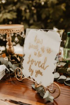 a sign that is sitting on top of a table with other decorations and items around it