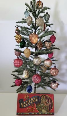 a small christmas tree with ornaments on it