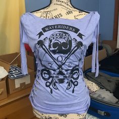 This Lavender/Light Blue Tank Top Has Cut Outs On The Sides And Ties Over The Shoulders! The Skull-Based Design Reads "Waveriders." The Size Is Xl But It Fits Quite Small. Light Blue Tank Top, Diy Cut Shirts, Tied Shirt, Off Shoulder Shirt, Tie Shirt, Blue Tank Top, Shoulder Shirts, Cut Shirts, Fancy Dresses