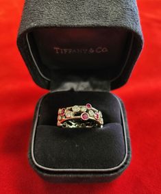 Tiffany & Co Platinum Diamond And Ruby Bubbles Band Ring Size 6 Tiffany & Co's Bubbles series ring with diamonds and rubies of varying sizes that make it look like beautiful bubbles floating on your finger. Ring and Stones are in great condition, very high quality, check photos for more details. It does come with the original inner Tiffany box.   Features: VS Quality Diamonds  F-G Color Diamonds 950 Platinum Purity Beautiful Different Sized Rubies Size: 6 Hallmarked "T & Co PT 950" With Original Box Weight: 9.95g Feel free to message us with any questions, we do ship fully insured to the Continental US only! JR C #188669 Tiffany Wide Band Ring, Tiffany Box, Bubble Ring, Finger Ring, Wide Bands, Quality Diamonds, Tiffany & Co., Band Ring, Colored Diamonds