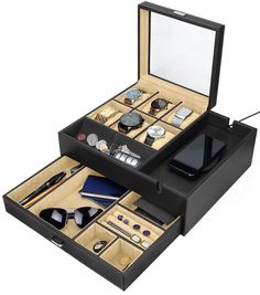 an open black jewelry box filled with personal items