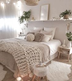 a bedroom decorated in neutral tones and white