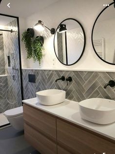 a bathroom with two sinks and mirrors on the wall