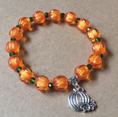 Pumpkin stretch beaded fashion charm bracelet This pumpkin charm bracelet is a super fun, bright piece to add to your fall jewelry collection! Wear it with other bracelets for a trendy stacked look. Wear anytime, anywhere!Handcrafted in the USA Featuring: orange pumpkin beads with tiny green glass beads to look like pumpkin stems — topped with a rustic pumpkin charm! Size: One size fits most Materials: acrylic beads, elastic cord, alloy Colors: Orange, green, silver *Actual color may appear diff Thanksgiving Bracelet Beaded, Trendy Beaded Jewelry Fall, Cheap Casual Halloween Bracelets, Cheap Orange Halloween Bracelets, Halloween Jewelry Diy, Halloween Beaded Jewelry, Pumpkin Stems, Pumpkin Beads, Beaded Fashion