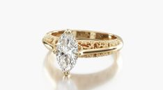 a gold ring with a pear shaped diamond