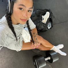 a woman with headphones sitting on the ground