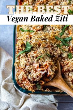 a casserole dish filled with vegetables and topped with breadcrumbs on a wooden spoon