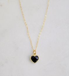 "Crafted onto a 14k gold filled chain and set in 24k gold electroplate, this black onyx heart is as precious as the affection it symbolizes. Make it that perfect gift for someone special, including yourself! Exuding protective and calming energies, Black Onyx is associated with the root chakra. It's believed to be an \"anti-panic\" stone which soothes stress and helps clear mental confusion and hyperactivity. GEMSTONE: Black Onyx STONE SIZE: average 10mm (.39\")  STONE SHAPE: Faceted Heart (Hear Black Gold-plated Adjustable Chain Jewelry, Black Enamel Necklace For Anniversary, Gold Plated Black Jewelry For Gift, Gold Onyx Jewelry For Gift, Black Necklaces For Anniversary On Valentine's Day, Black Gold Plated Jewelry As Gift, Black Gold Plated Jewelry Gift, Black Gold Plated Jewelry For Gift, Black Gold-plated Jewelry For Gifts