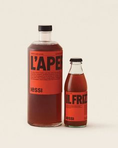 a bottle of liquid sitting next to a glass container with the label l'ape on it