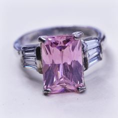 Size 5.75, Vintage Sterling silver fashion ring, 925 silver with emerald cut pink Quartz and clear crystal details, stamped 925 Pink Sterling Silver Crystal Ring With Center Stone, Pink Sterling Silver Crystal Ring For Formal Occasions, Fine Jewelry Pink Ring Stamped 925, Pink Fine Jewelry Ring Stamped 925, Pink Topaz Center Stone Ring In Sterling Silver, Pink Emerald Cut Sterling Silver Ring, Fine Jewelry Pink Rectangular Rings, Pink Topaz Ring With Accent Stones In Sterling Silver, Pink Sterling Silver Rings For Weddings