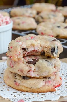 two cookies stacked on top of each other next to a bowl of candy canes