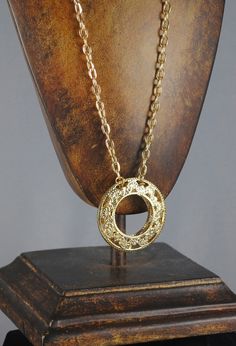 "FABULOUS Donut Vintage Pendant. It is gold toned and from the 1960s. Never before worn. In excellent vintage condition. Beautiful filigree work within the pendant! This pendant has two pieces, as you can see in the last photo! For those of you who are handy, you could actually turn them into hoop earrings! (Just a vintage repurposed idea Hangs from a fabulous 22\" vintage chain. The pendant measures 1 7/8\" in diameter. Perfect addition to your vintage collection!" Retro Gold-tone Jewelry Gift, Retro Gold-tone Jewelry For Gift, Retro Gold Jewelry For Gifts, Vintage Gold Round Jewelry, Vintage Round Gold Jewelry, Retro Brass Pendant Jewelry, Costume Jewelry Brass Necklace With Round Pendant, Brass Round Pendant Necklace Costume Jewelry, Brass Round Pendant Necklace In Costume Jewelry Style