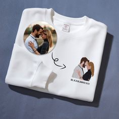 a white t - shirt with an image of a man and woman on it