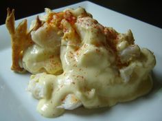 a white plate topped with mashed potatoes covered in gravy